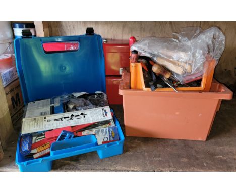 A shelf of used and unused hand tools to include a set of Jack chisels, and two red metal tool boxes. 