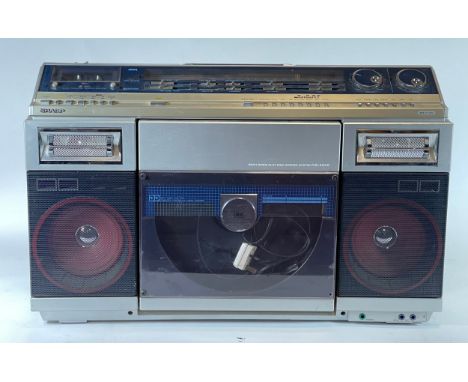 A Sharp portable music system, model VZ-2000E, comprising of tape player, record player and radio. 