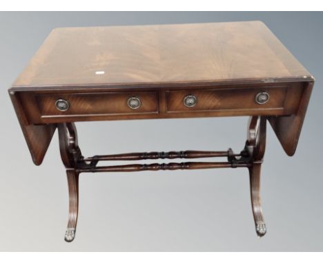 A reproduction mahogany drop leaf sofa table 