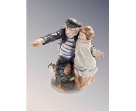 A Lladro group figure of a sailor with child together with two Nao figures and another Spanish figure 