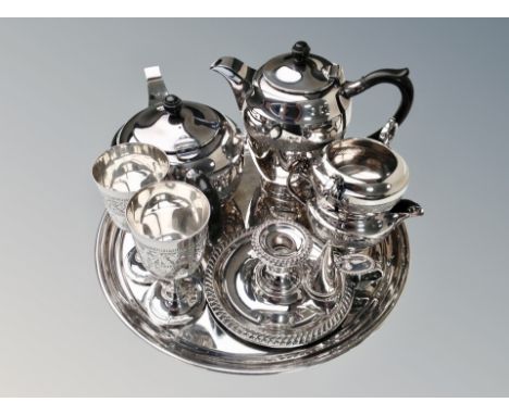 A silver plated four piece tea service on circular tray, pair of goblets and chamber stick 