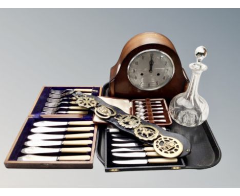 An eight day mantel clock with silvered dial, crystal decanter, horse brasses, three boxed sets of cutlery 