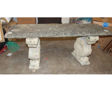 'A  cast concrete garden bench on ram's head and acanthus supports, 124cm long, 50cm high.