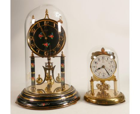 Kundo glass domed mantle clock with instructions and key, together with a smaller Koma domed mantle clock. Height of tallest 