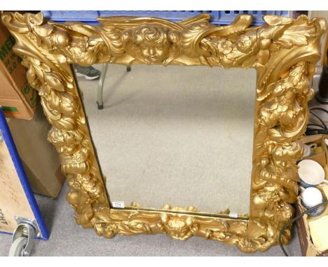 Antique large embossed mirror with images of cupids and foliage. 85cm x 71cm 