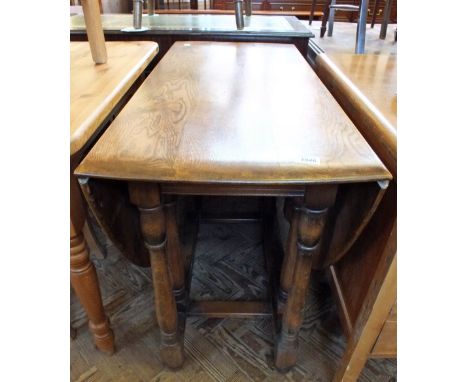 An Ercol flap leaf dining table