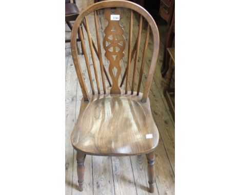 Four Ercol wheel back dining chairs