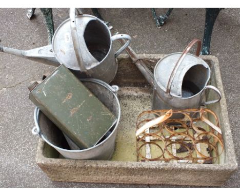 A planter sink with two watering cans, milk bottle holder and galvanised bucket