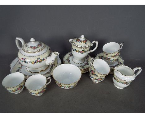 A Crown Staffordshire tea service with floral decoration comprising teapot, milk jug and sugar bowl, six cups, six saucers, s