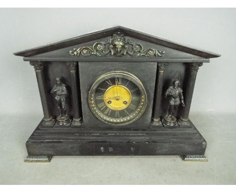 A late 19th century French black marble mantel clock, the case of architectural form with bronzed mounts and flanked by six c