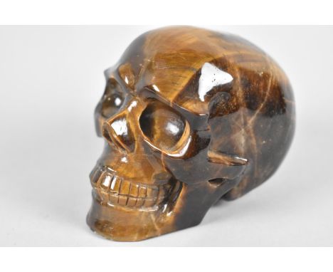A Reproduction Carved Tigers Eye Skull, 7cm high 