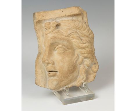 Relief with Apollo; Rome, Imperial period, 2nd-3rd century ADCarved marble.Size: 24 x 21 x 7 cm.Marble fragment in which the 