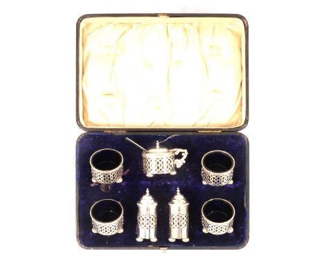 A silver seven-piece condiments set, Robert Chandler, Birmingham 1906, comprising four salts, one mustard and two pepperettes