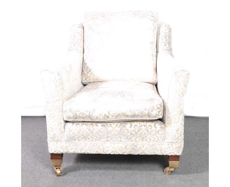 Modern easy chair, slightly winged back with square arms, mahogany legs on brass casters, light blue sculpted upholstery, wid