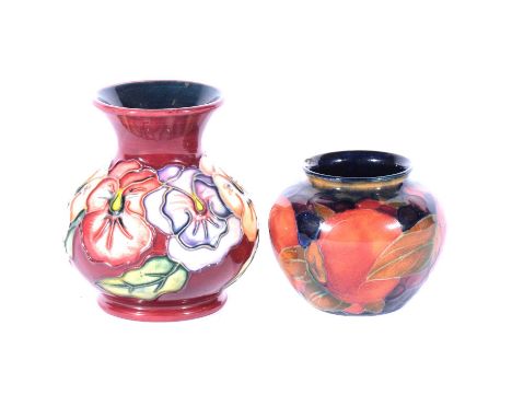 Moorcroft Pottery - a small Pomegranate pattern vase, signed WM in green, 7cm; and a modern Pansy pattern vase, bulbous form,