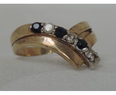 A ladies 9ct gold wish bone ring set with sapphires and cubic zirconia,  approx 2.7g