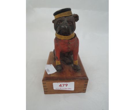 An early 20th century novelty painted treen battery lamp modelled as bellboy Pug dog