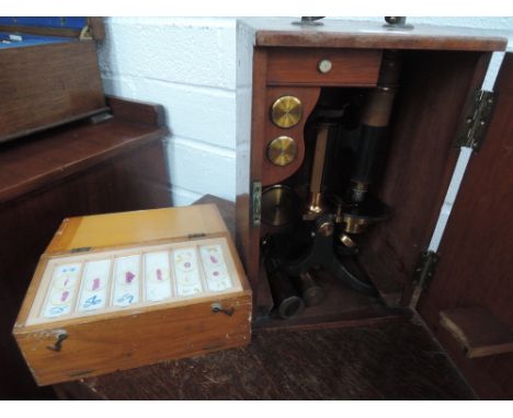 A vintage lacquered brass microscope and accessories in fitted mahogany case, marked Carey London HO 8 (military issue), with