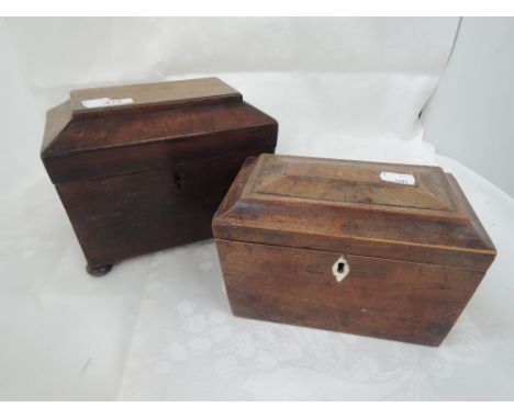 A 19th century Regency mahogany tea caddy of sarcophagus shape on bun feet and a similar tea caddy