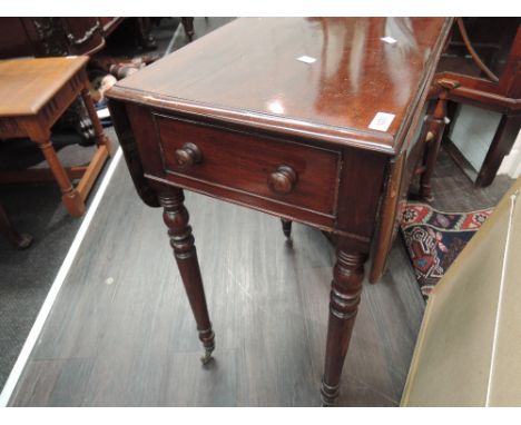 A 19th century mahogany Pembroke table having drop leaf top with frieze drawer on ring turned legs