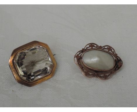 A yellow metal brooch stamped 9ct having  mother of pearl decoration in a decorative mount and another octagonal brooch havin