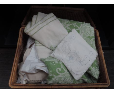 A picnic hamper containing a selection of linen and lace including tray clothes, handkerchiefs, shoe bag, bobbin lace collars