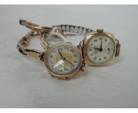 A ladies vintage 9ct gold wrist watch having an Arabic numeral dial to an engine turned face on a yellow metal stretch strap 