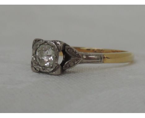 A ladies diamond solitaire ring, approx .25ct in a square mount to decorative shoulders on a yellow metal loop stamped 18ct &