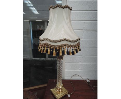 A modern brass and glass table lamp of Corinthian column design having fringed shade