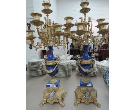 A pair of late 20th century reproduction Italian style candelabra having cast decoration and blue ceramic body