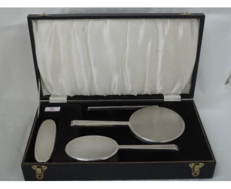 A cased four piece silver dressing table set having engine turned decoration, Birmingham 1966, W I Broadway & Co