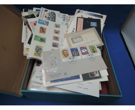 A box of stamps, postcards and first day covers