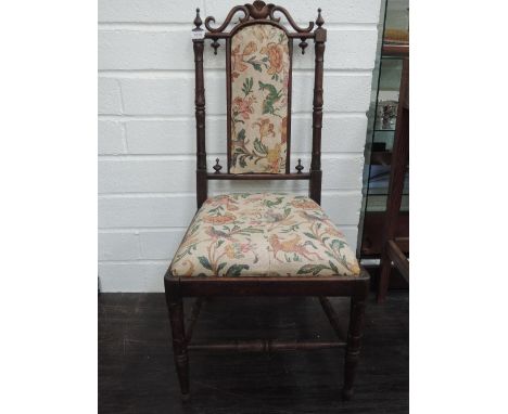 A late Victorian rosewood bedroom chair having scroll and pillar back with later tapestry upholstered panels and turned legs