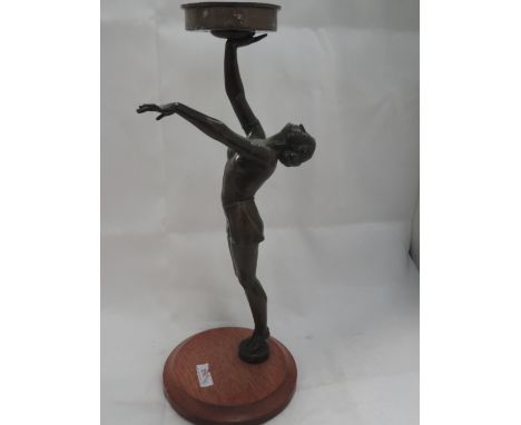 A late 20th century reproduction spelter lamp figure in the Art Deco style modelled as semi naked lady holding aloft platform