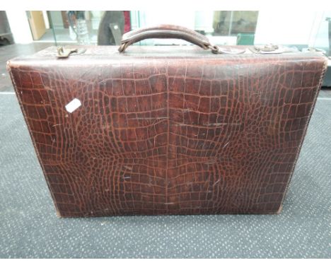 A vintage leather suitcase of crocodile skin effect, labelled Arthur Barber, trunk and suitcase maker, Bradford