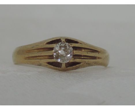 A gents yellow metal signet ring stamped 18 having an inset diamond,  approx .25ct in an open setting