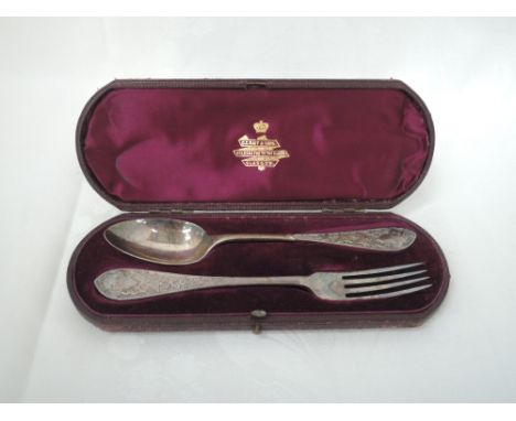 A cased Victorian silver spoon and fork having moulded ivy leaf decoration and monograms to terminals, London 1879, Martin Ha