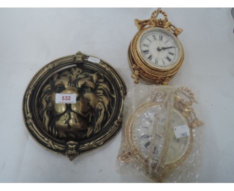 A cast brass reproduction door knocker modelled a a lion's face and two late 20th century decorative American clocks