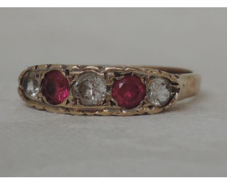 A ladies dress ring having two rubies interspersed by spinels in a moulded gallery mount on a 9ct gold loop