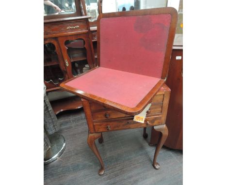 An early 20th century mahogany card table/chest having baize swivel top on double false and fitted drawer on cabriole legs