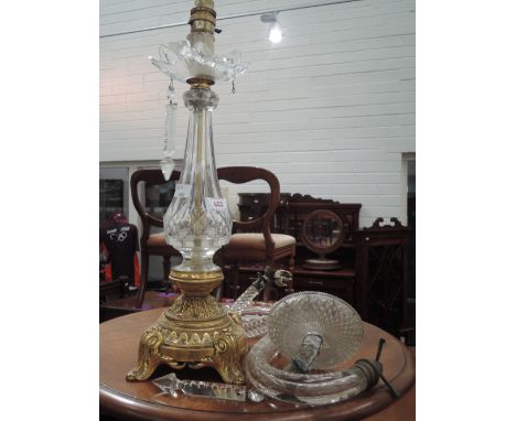 A 20th century table lamp of glass lustre form having brass ormolu effect base and two glass wall light sconces