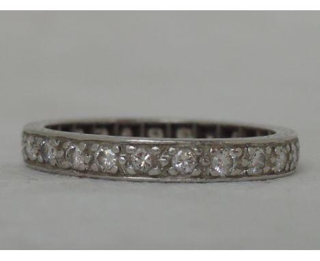 A ladies diamond full eternity ring on a white metal loop stamped plat, size O