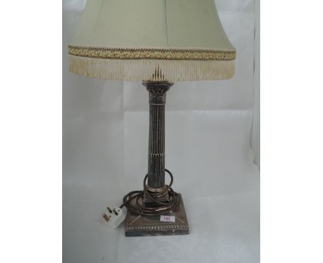 A table lamp made out of a converted silver plated candle stick of Corinthian design on a square base