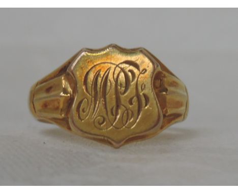 A 9ct gold signet ring having a monogrammed shield cartouche and moulded shoulders, Chester hallmark,  approx 4.4g