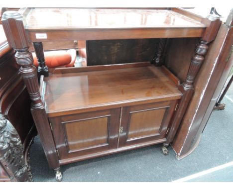 A late Victorian mahogany buffet having shelf top and cupboard undertier with pillar supports