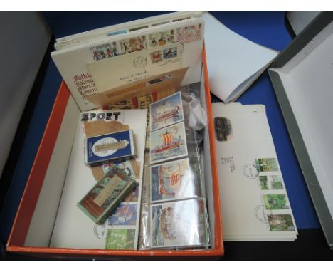 A box of first day covers and cigarette cards, full and part sets