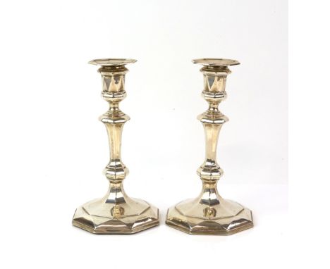 George V pair of silver candlesticks, the octagonal facetted bases filled, by James Deakin &amp; Sons (John &amp; William F D