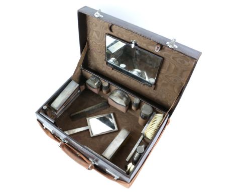 George VI silver-mounted travelling dressing table set and vanity case, by Mappin &amp; Webb, London 1947, comprising brushes