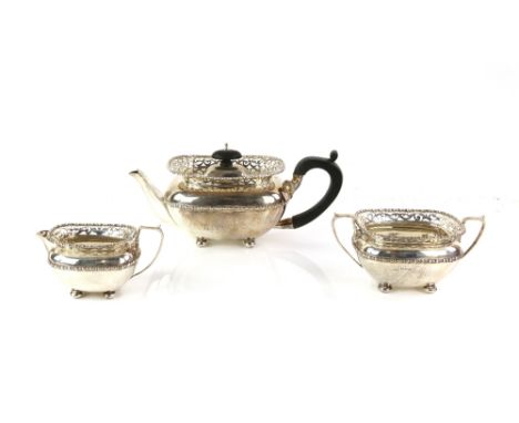 George V silver three-piece bachelor tea service, by Henry Matthews, Chester 1911, with pierced gallery borders on bun feet, 