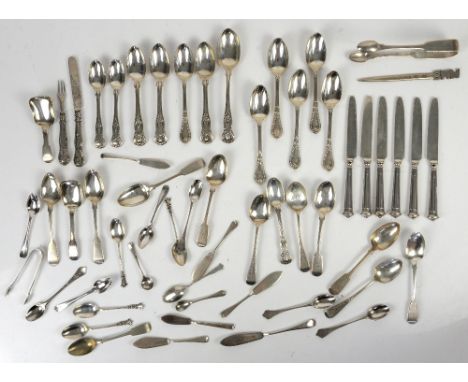 Large group of silver teaspoons and other items, including butter knives, caddy spoons, sugar nips, various dates, makers and